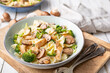 Mushroom pasta salad with steamed broccoli and baked chicken meat slices
