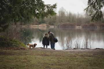 father and daughter and dog out fishing 