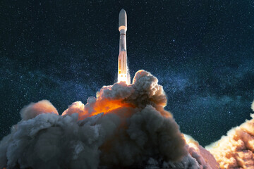 Fototapete - Spacecraft takes off into the starry blue sky with the milky way. Successful launch of a rocket into space. Travel the universe and explore space