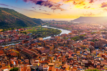 Aerial view of the beautiful village of Bosa with colored houses and a medieval castle. Bosa is located in the north-wesh of Sardinia, Italy. Aerial view of colorful houses in Bosa village, Sardegna.