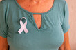 © Leonidas - elderly woman wearing a white ribbon, representing the mental health prevention campaign. White January.