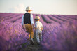 Two brothers are walking in a lavender field