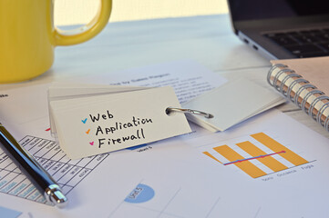 Poster - there is a wordbook on a desk with randomly placed dummy papers on it. the word web application fire
