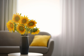 Wall Mural - Vase with beautiful yellow sunflowers on table in room, space for text