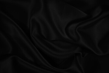 Wall Mural - Black silk satin background. Dark elegant abstract background. Wavy soft folds on the fabric.