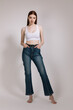 © olgalisa88 - Girl in jeans and barefoot posing on a white background