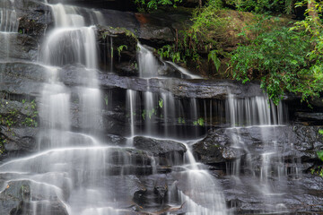  Rocky waterfall cascade with tree.