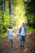 © romankosolapov - Beautiful boy and girl walking in the beautiful summer forest