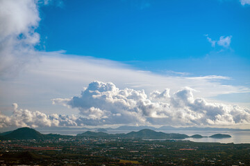 Poster - The landscape of the mountain ridge of Phuket and the Adaman Sea against the background of a blue sky with clouds.