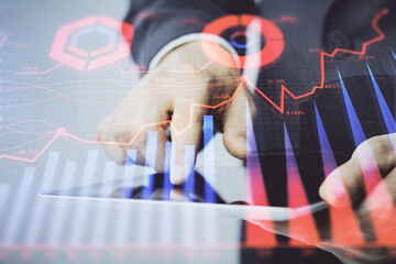 Multi exposure of man's hands holding and using a phone and financial chart drawing. Market analysis concept.