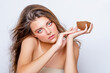 © Julia - Beauty face. young Woman with natural makeup and healthy skin. Beautiful caucasian girl model looks into the camera holding a coconut in her hand. closeup. Beauty and Skin care concept.