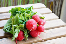 Selective Focus Closeup Of A Bunch Of Red Radish On A Wooden Surface