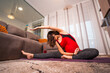 © unai - Young pregnant Caucasian woman doing yoga and pilates stretching at home. Online exercises in prepartum classes, pregnancy wellness