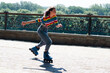 © queen1987 - Cheerful beautiful teenage girl rollerblading in the park on a warm summer morning
