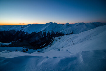 Breathtaking winter sunset landscape at high altitude with colored sky