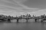 Fototapeta Mosty linowy / wiszący - View of the skyline of the city of Frankfurt am Main in black and white, Germany