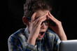 © Mitch Shark - Student ruffles hair on computer is amazed
