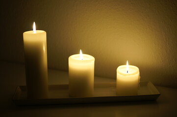 Three candles burning in the dark