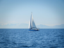 Sailboat On Calm Waters Under A Clear Blue Sky