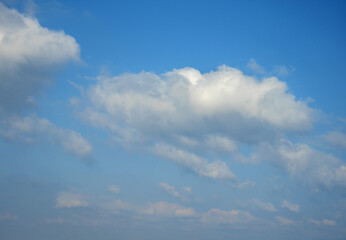 Low angle shot of fluffy clouds against a blue sky