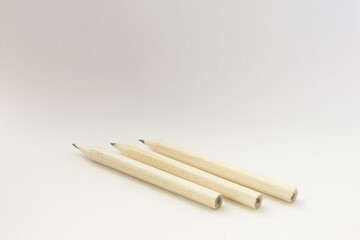 Poster - Closeup shot of wooden pencils on an isolated white background