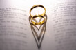 Closeup of wedding rings forming heart shapes on the bible - concept of love and marriage