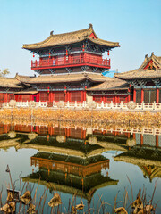 Poster - Historic Buddhist temple with a zen garden reflecting in a lake in China under a bright sky