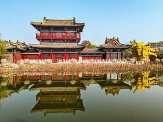 Poster - Historic Buddhist temple with a zen garden reflecting in a lake in China under a bright sky