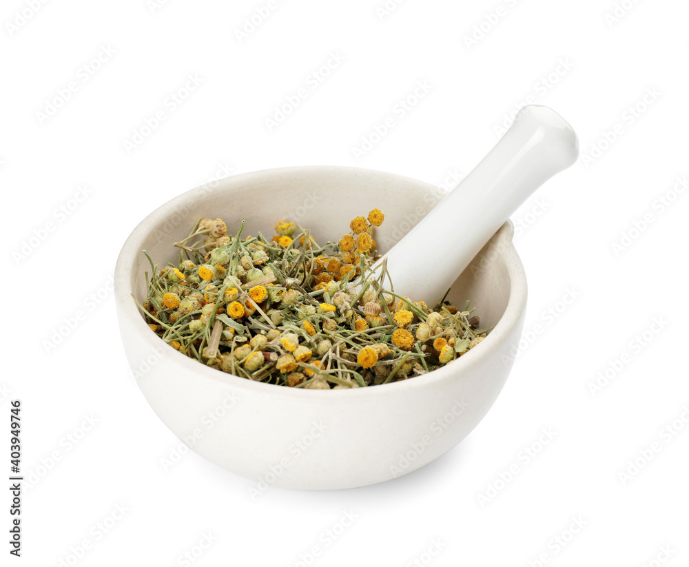 Mortar with dried herbs on white background