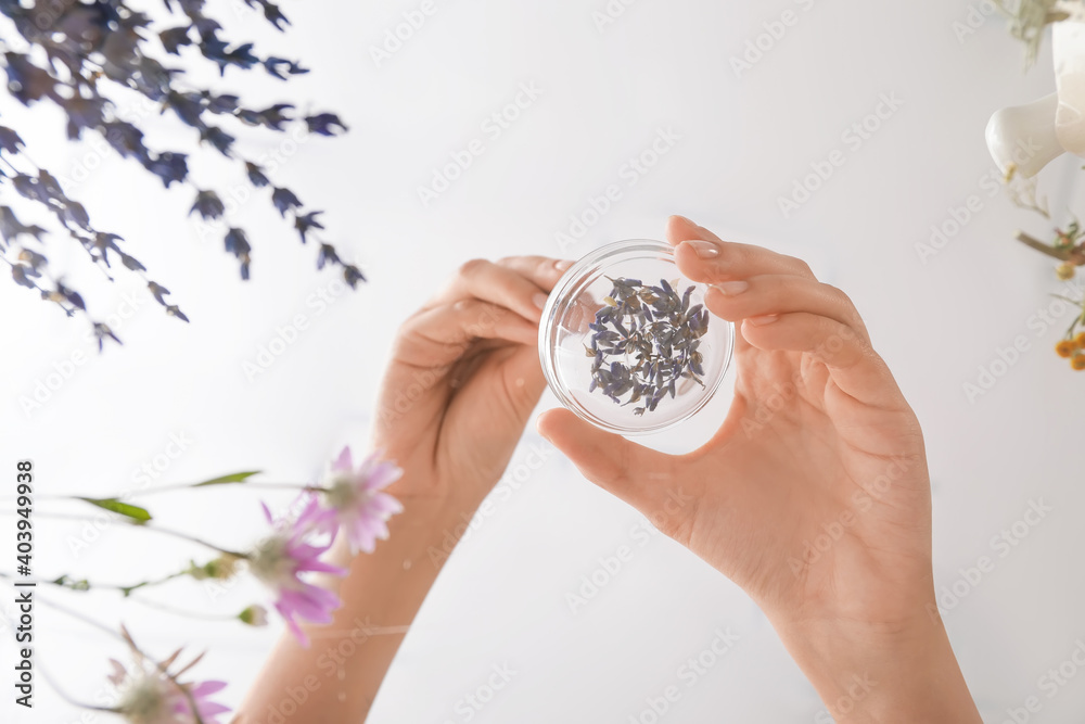 Woman making herbal based medicines on table