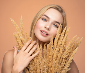 Wall Mural - Portrait of young beautiful woman with a healthy  skin of face.  Attractive girl with a bunch spring field flowers