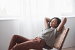 Leinwandbild Motiv Young woman relaxing at home. African american girl resting in her room. Enjoy life, rest, relaxation, wellbeing, lifestyle, people, recreation concept