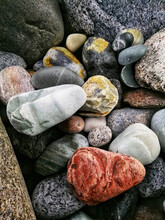 Closeup Vertical Shot Of A Pile Of Colorful Pebble Stones On A Molen Beach In Norway