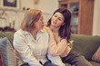 © yavdat - middle aged mother grown up adult daughter laughing enjoy spend time together embracing having fun, two different generation relative people