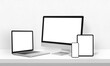Display mockups for responsive web page design promotion. Laptop, computer display, phone and tablet on desk