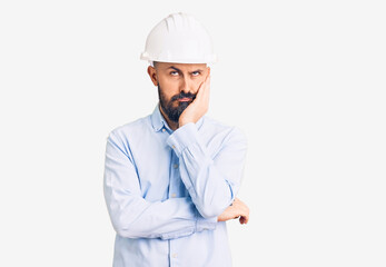 Poster - Young handsome man wearing architect hardhat thinking looking tired and bored with depression problems with crossed arms.