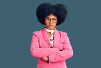 Poster - Young african american girl wearing business clothes and glasses skeptic and nervous, disapproving expression on face with crossed arms. negative person.