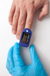 © Larisa - Doctor's hand in blue gloves checks the oxygen saturation of the patient using an oximeter