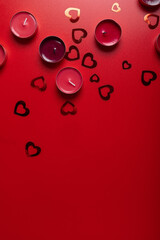 Wall Mural - Red candles and hearts on red background