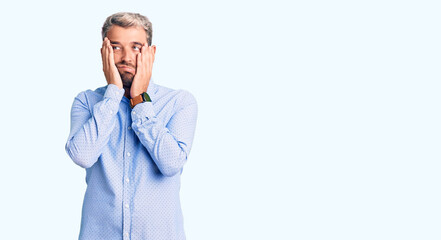 Sticker - Young handsome blond man wearing elegant shirt tired hands covering face, depression and sadness, upset and irritated for problem