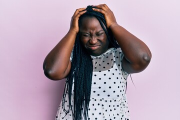 Poster - Young black woman with braids wearing casual clothes suffering from headache desperate and stressed because pain and migraine. hands on head.