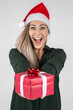 © MrsLePew - young blond girl with Santa hat and red gift/present ist surprised an smiles