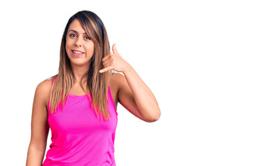 Wall Mural - Young beautiful woman wearing sportswear smiling doing phone gesture with hand and fingers like talking on the telephone. communicating concepts.