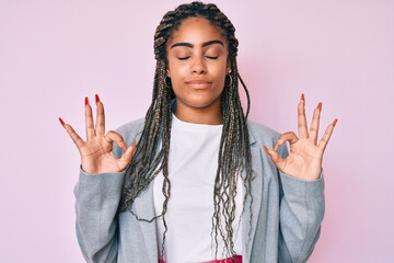 Wall Mural - Young african american woman with braids wearing business jacket relax and smiling with eyes closed doing meditation gesture with fingers. yoga concept.