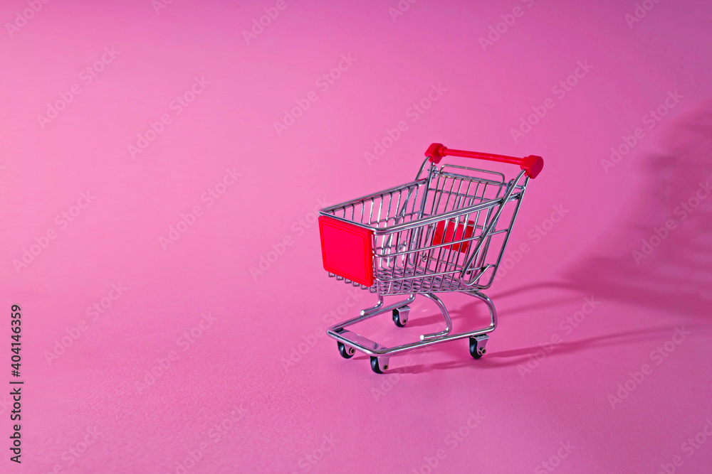 Empty Shopping Cart Over Pink Background - obrazy, fototapety, plakaty 