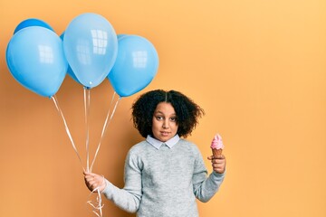 Poster - Young little girl with afro hair holding ice cream and blue balloons clueless and confused expression. doubt concept.