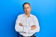 © Krakenimages.com - Middle age indian man with arms crossed gesture clueless and confused expression. doubt concept.