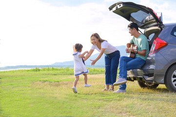 Asian family.happy little girl with family sitting in the car.Car insurance concept