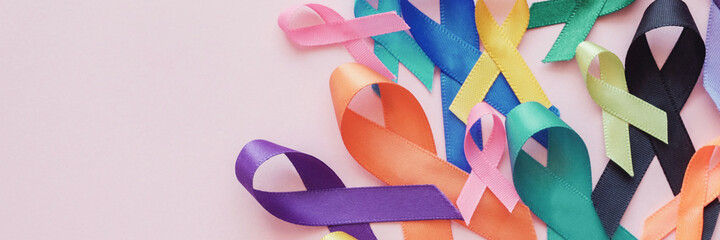 Wall Mural - All color ribbons on pink background, cancer awareness, World cancer day