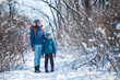 © zhukovvvlad - Woman with a child on a winter hike in the mountains.